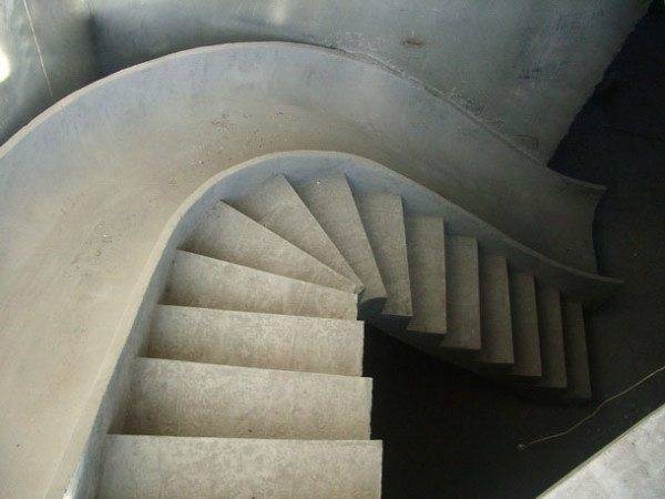A finished staircase with a cast slide for descent