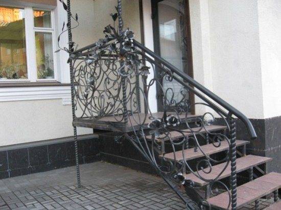 Wrought iron porch pillars and railings decorated with steel flowers