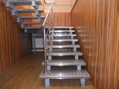 Indoor metal staircase with wood trim.