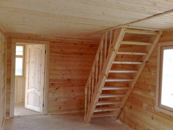 The photo shows a wooden staircase to the attic.