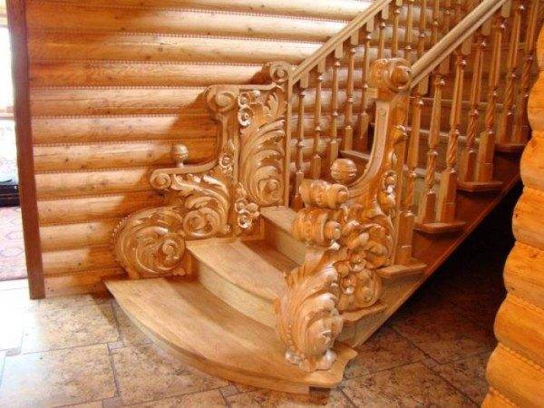 Sur la photo - un escalier en frêne décoré de sculptures